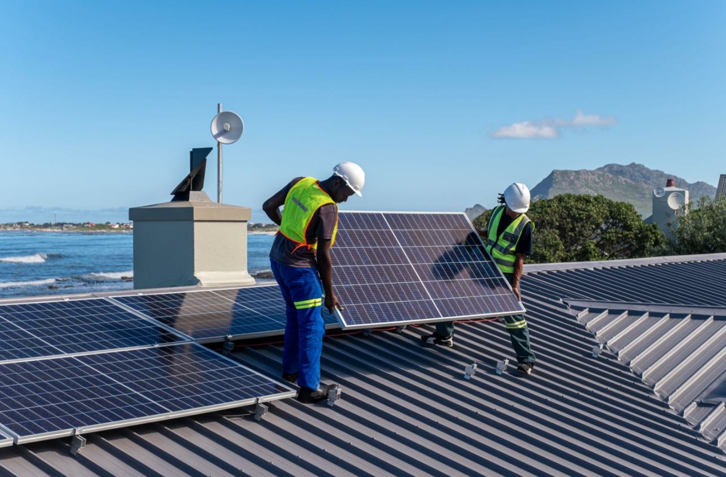 Solar panels converting sunlight into electricity on a residential rooftop.