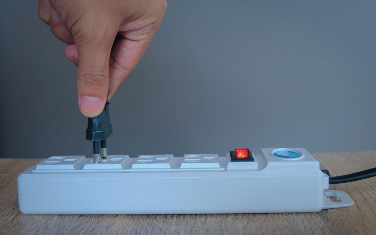 Person reducing electricity bill by using energy-saving appliances and LED lighting at home